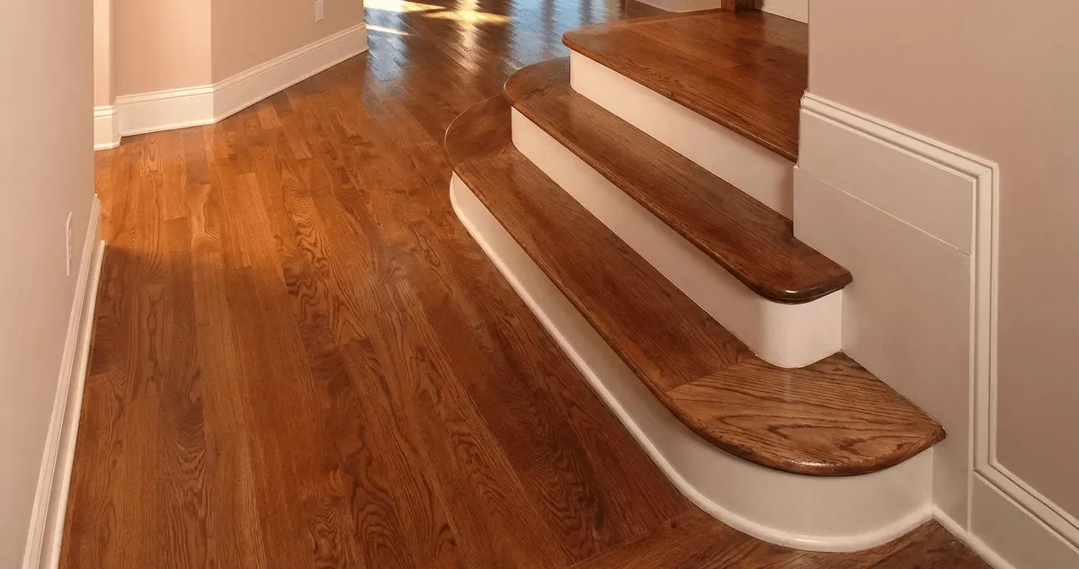 Base floor of a staircase with professionally restored wood flooring in Minneapolis MN